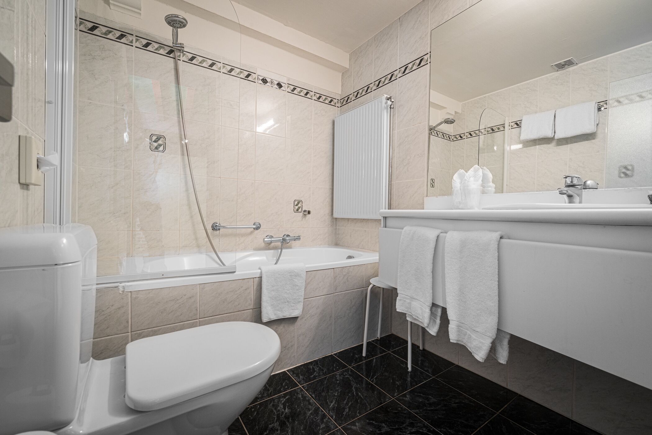Un baño moderno con inodoro, bañera y ducha.