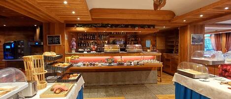 A buffet area with a wooden ceiling and a stone wall.