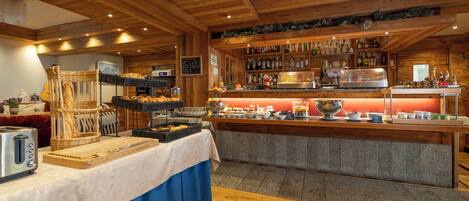 A buffet setup with bread baskets, a toaster, and a variety of beverages.