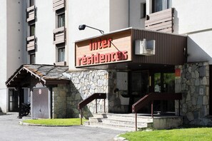 A building with a sign reading 'inter residences' and a stone facade.
