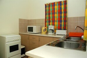 Fridge, microwave, coffee/tea maker, cookware/dishes/utensils