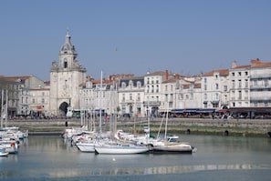 Experience the unique blend of classical and modern architecture in this historic waterfront setting, where boats and lively atmosphere come together.