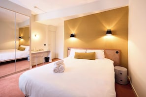 Premium bedding, desk, laptop workspace, blackout curtains