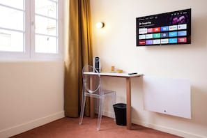 Premium bedding, desk, laptop workspace, blackout curtains