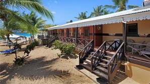 A beachfront hotel with a sandy beach, palm trees, and a pool area. - Mary's Boon Beach Resort & Spa (Simpson Bay)