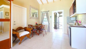 A spacious kitchen with a dining area, a large mirror, and a view of the outside. - Mary's Boon Beach Resort & Spa (Simpson Bay)