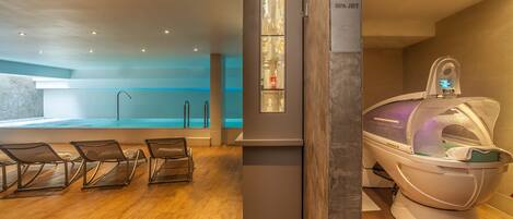A spa area with a massage chair, a sauna, and a pool.