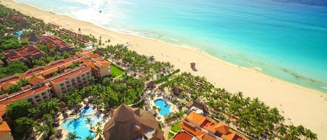 On the beach, white sand, sun-loungers, beach umbrellas
