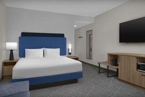 A hotel room with a bed, a TV, a coffee machine, and a desk. - Hampton Inn & Suites Colorado Springs/I-25 South (Colorado Springs)