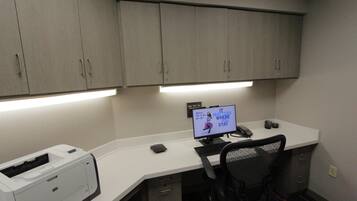 A modern office space with a desk, computer, printer, and office chair.