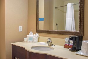 A hotel bathroom with a sink, mirror, and toiletries. - Hampton Inn Murphy (Murphy)