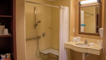 A bathroom with a shower, a sink, a mirror, and a shelf with toiletries.