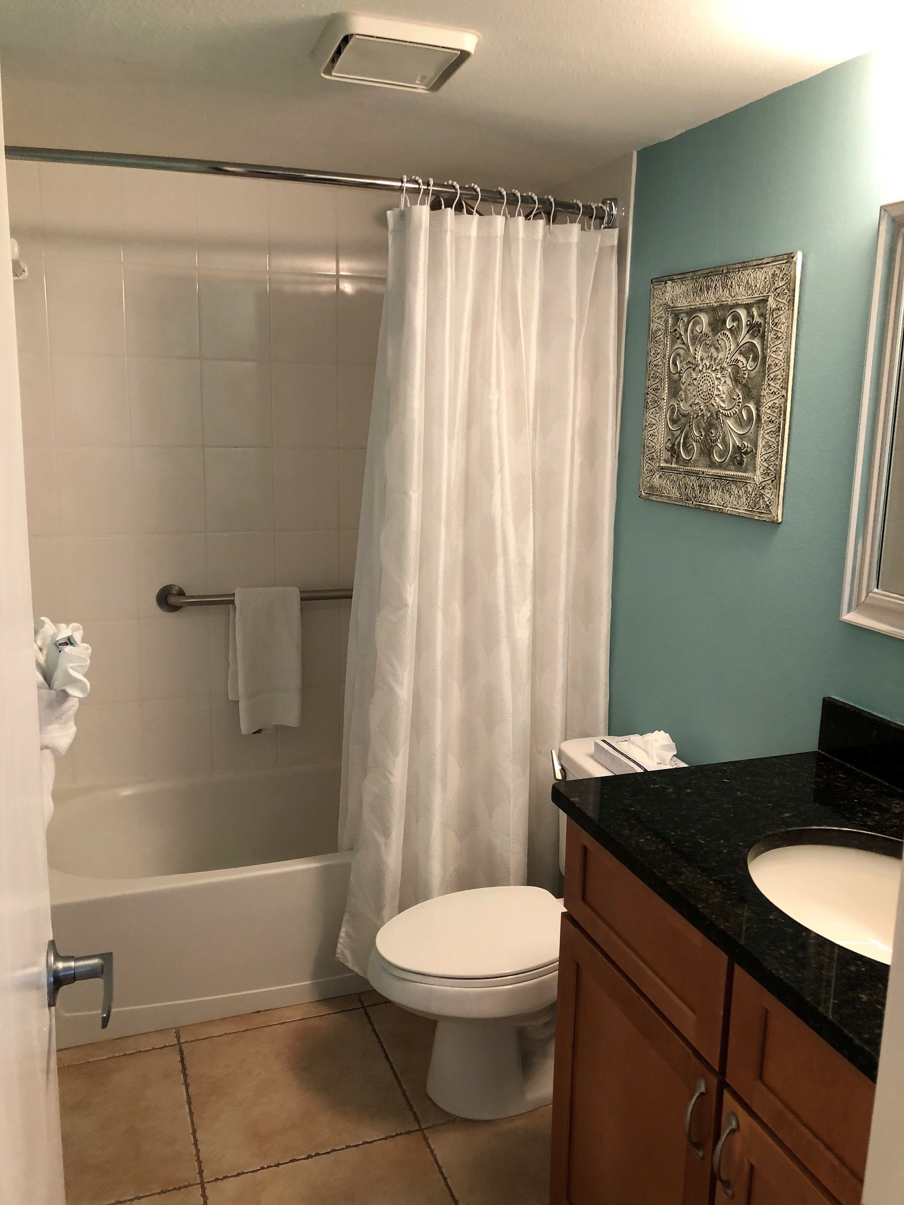 Ein Badezimmer mit Badewanne, Toilette und Waschtisch.