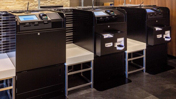 A row of self-service kiosks with touchscreens and card readers, likely for check-in or payment. - Comfort Hotel Hakodate (Hakodate)