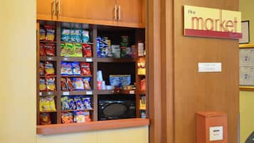 A snack display with various chips and a microwave.