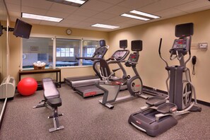 A fitness center with treadmills, elliptical machines, a bench, and a red exercise ball. - Towneplace Suites Marriott Meridian (Meridian)