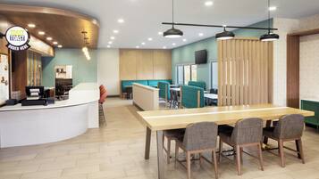 A modern restaurant interior with a counter, seating area, and a dining table.