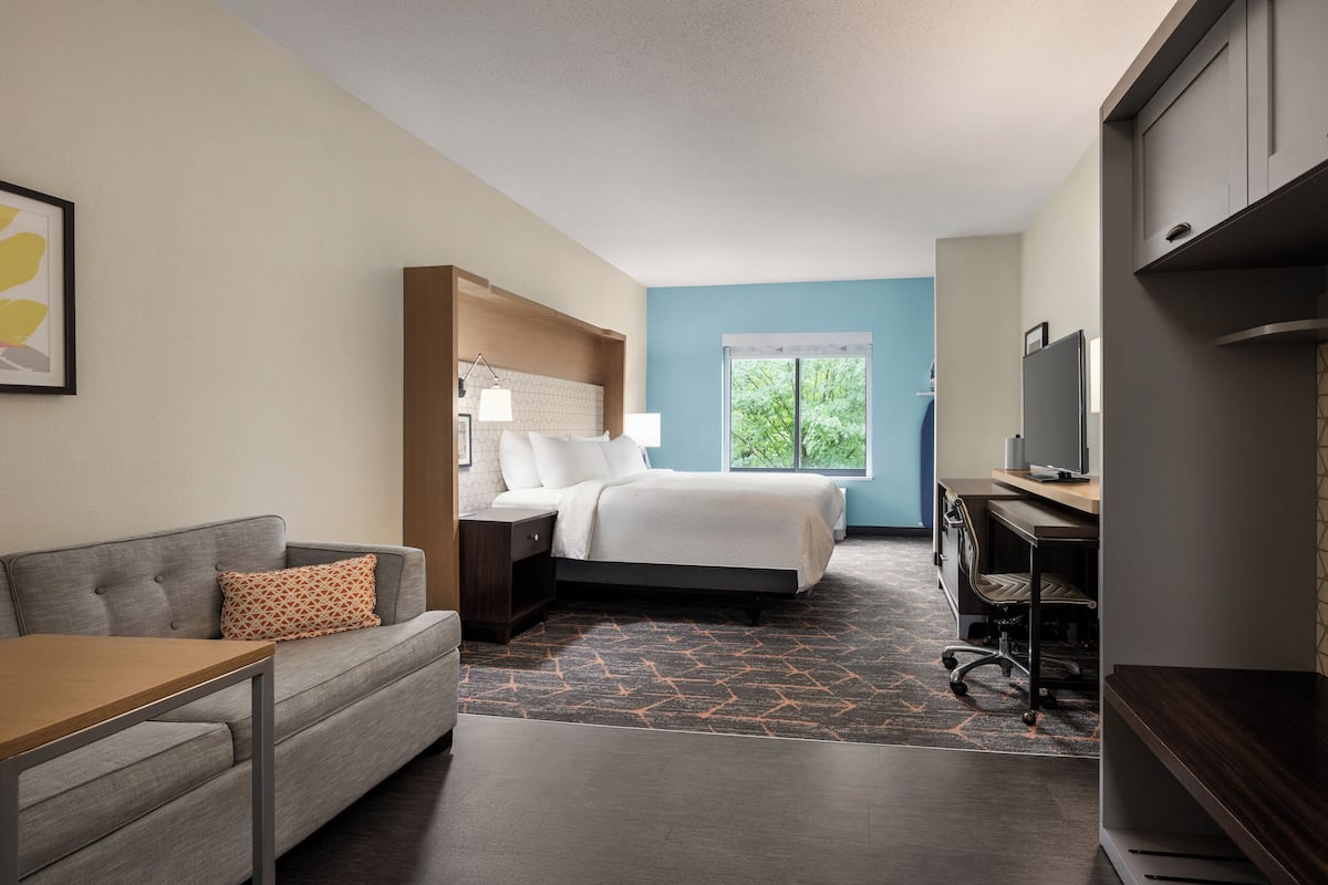 Premium bedding, desk, laptop workspace, iron/ironing board