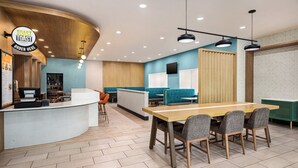 A modern restaurant interior with a curved counter, seating area, and a wooden ceiling. - Holiday Inn Cheshire - Southington by IHG (Southington)
