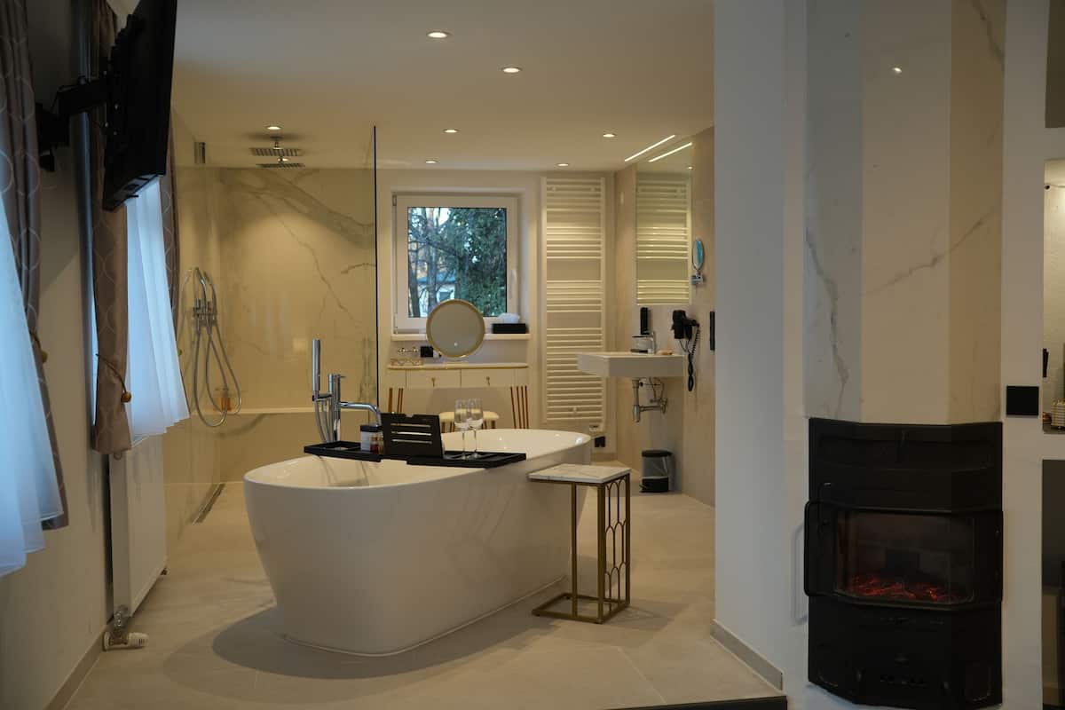 deluxe studio suite, 1 king bed | bathroom | hair dryer, towels