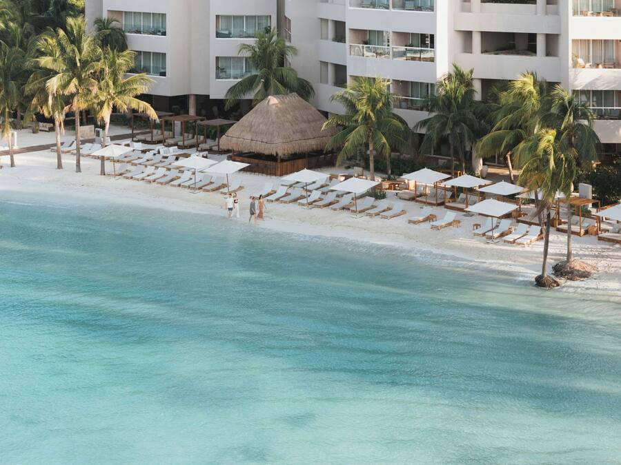 On the beach, white sand, sun loungers, beach umbrellas