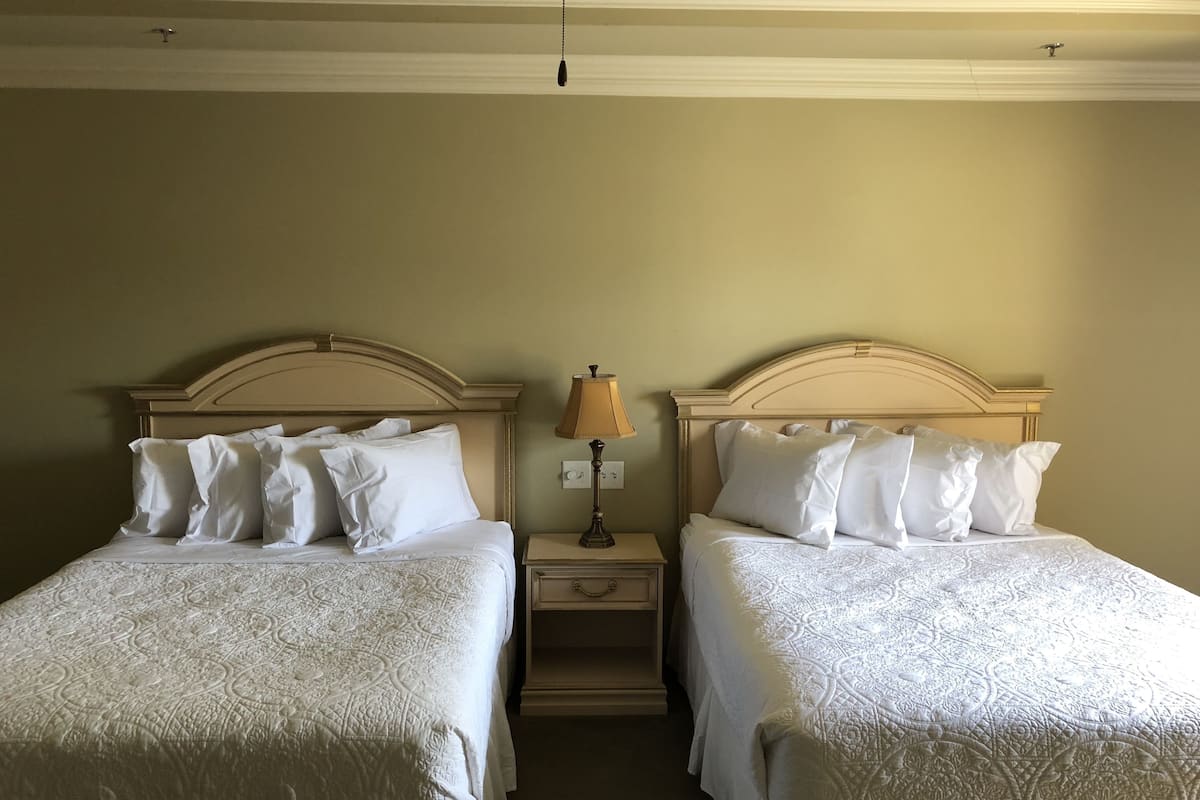 standard room, 2 queen beds, non smoking | pillow-top beds, desk, blackout curtains, iron/ironing board