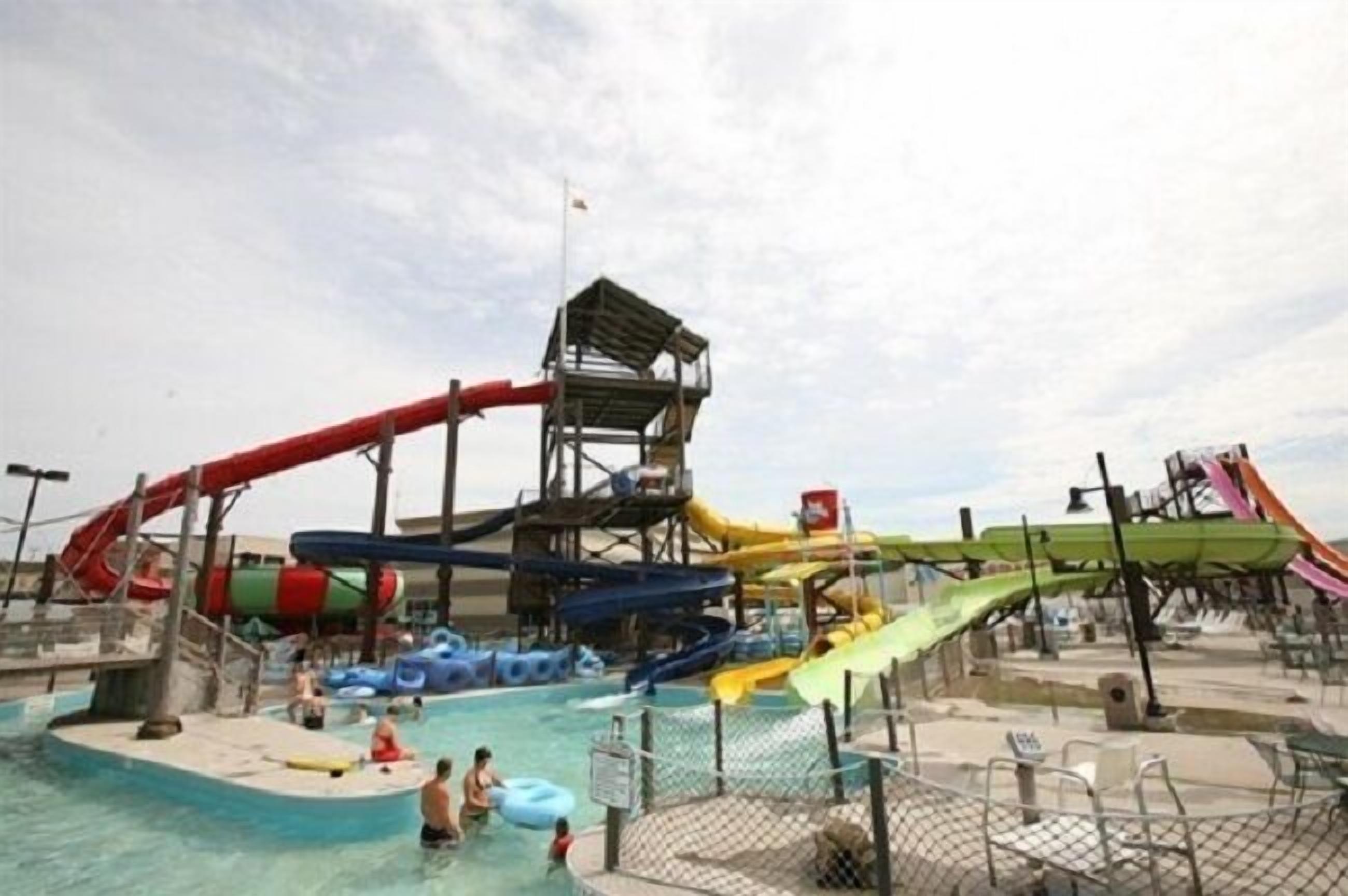 A water park with multiple water slides and a pool area.