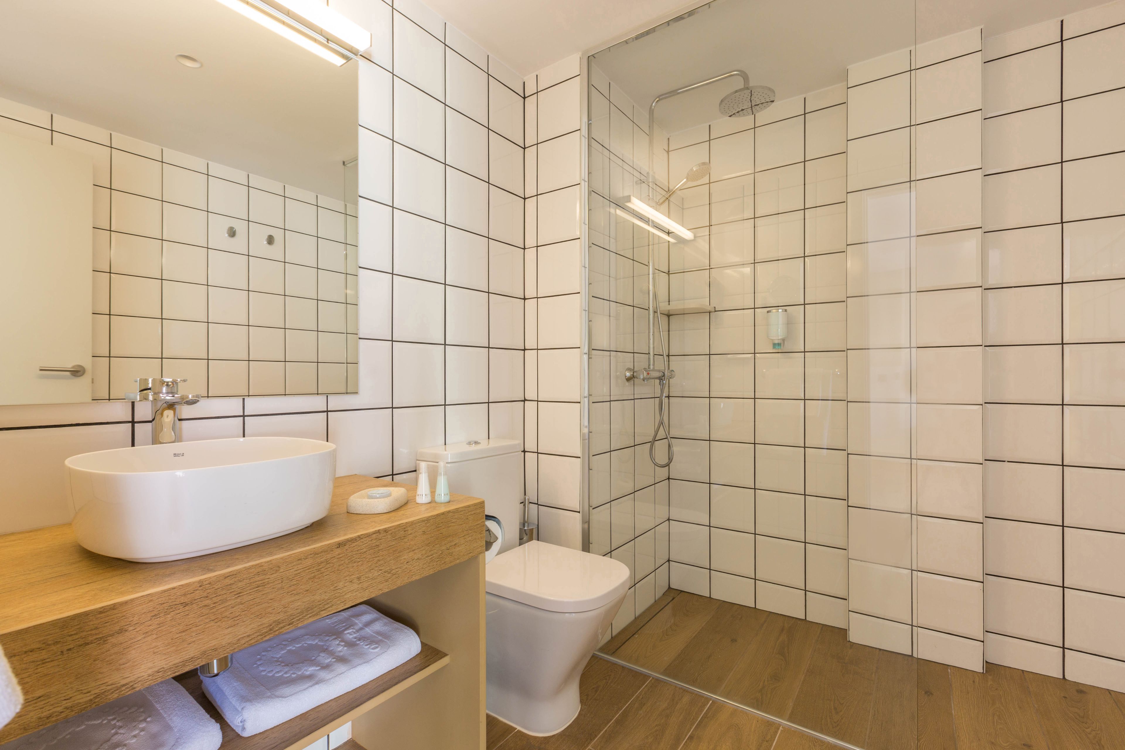 deluxe double room, 1 king bed | bathroom | shower, hair dryer, towels