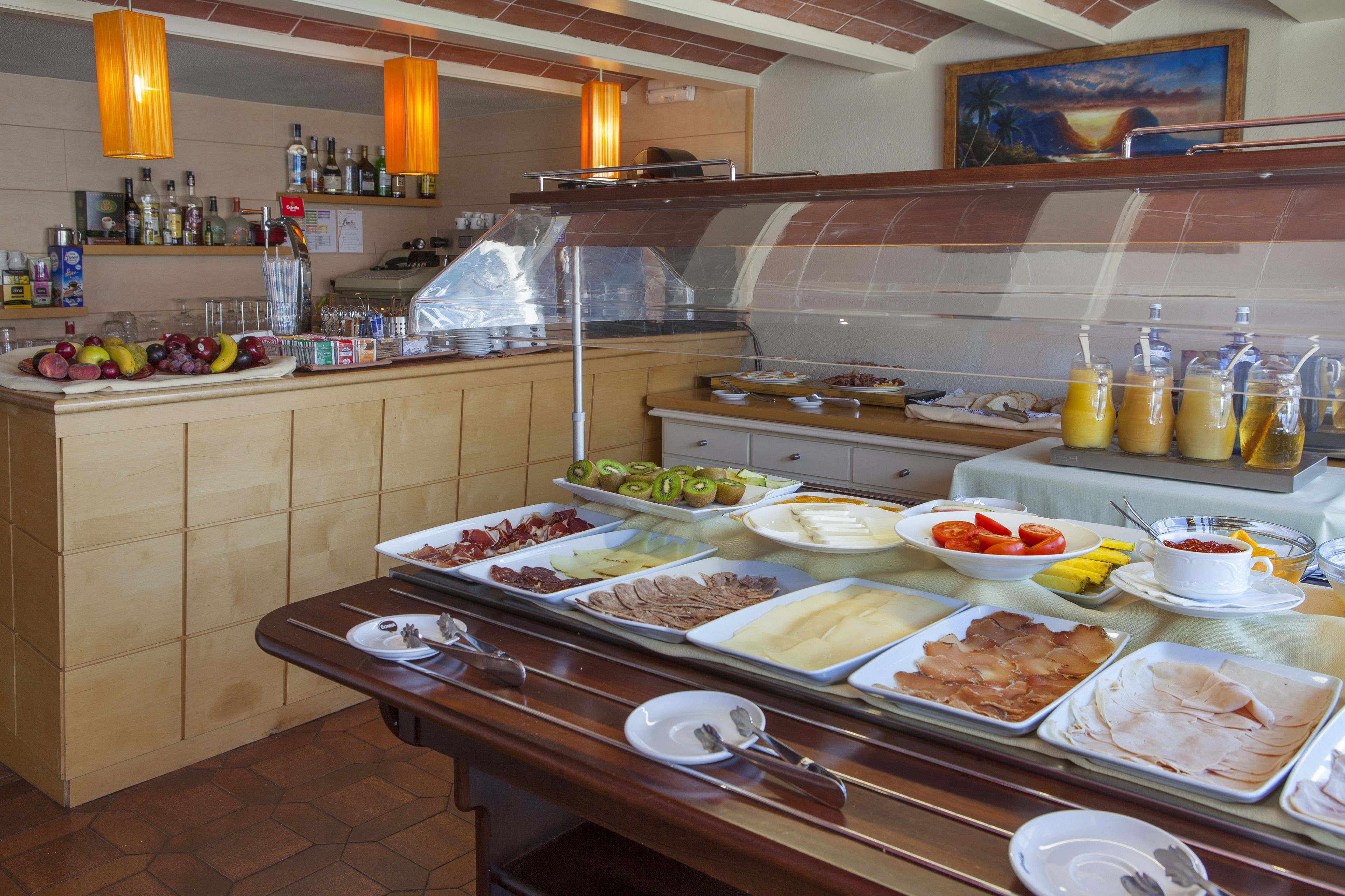 A buffet with various food items and beverages.