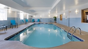 An indoor swimming pool with clear water, surrounded by blue chairs and a tiled deck. - Comfort Inn & Suites Charleston Airport Convention Center (North Charleston)