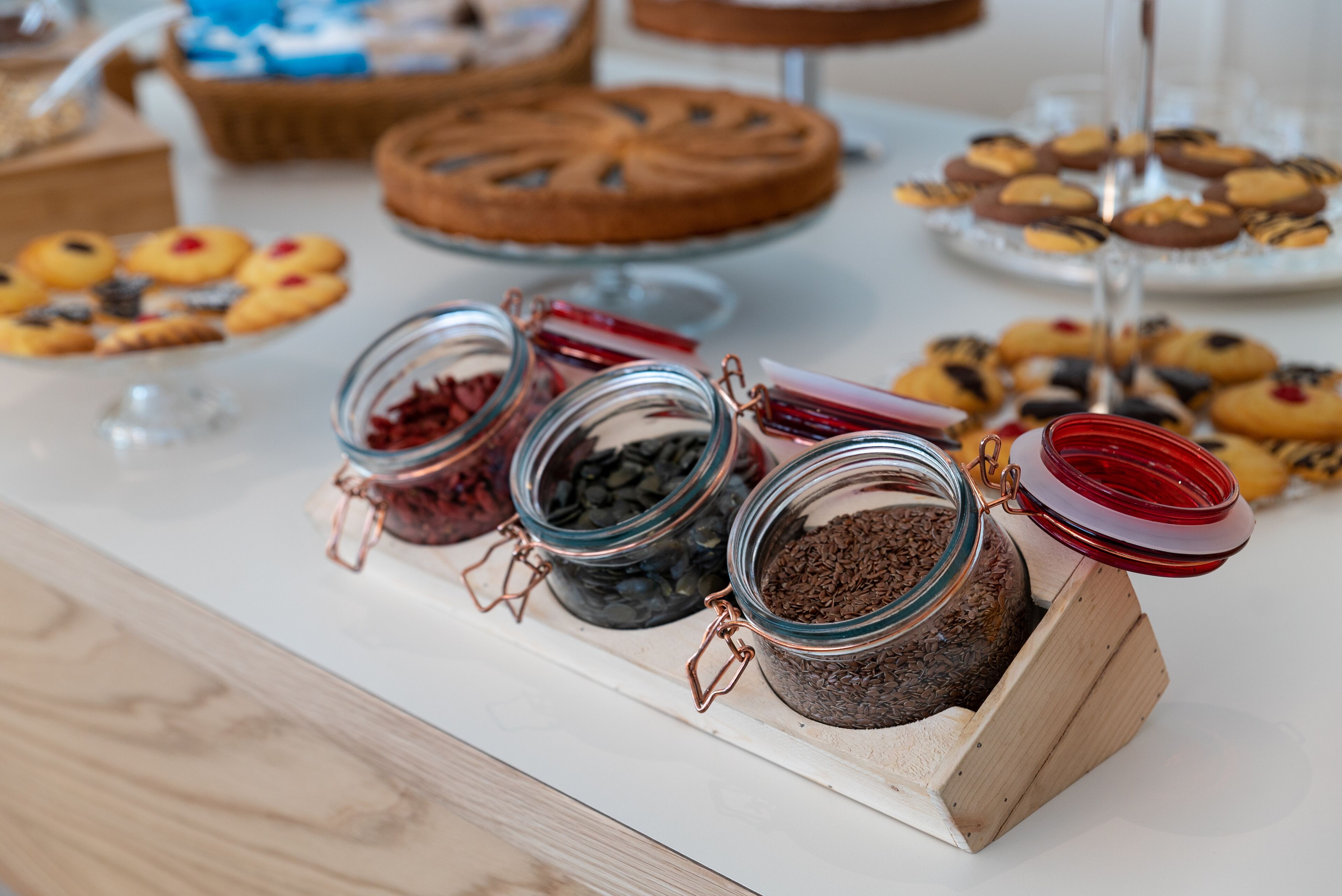 A buffet table with various food items and jars of spices.