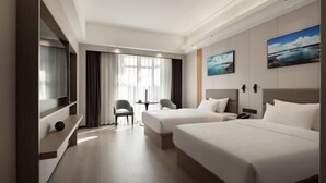 A hotel room with two beds, a TV, a desk, and a chair. - Centron International Hotel (Longyan)