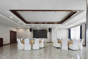 A conference room with a long table, chairs, a projector screen, and a podium. - Centron International Hotel (Longyan)