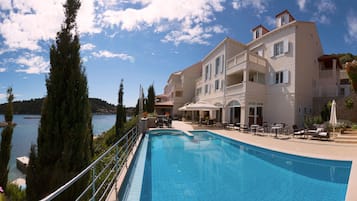 Outdoor pool, open 10:00 AM to 7:00 PM, pool umbrellas, pool loungers