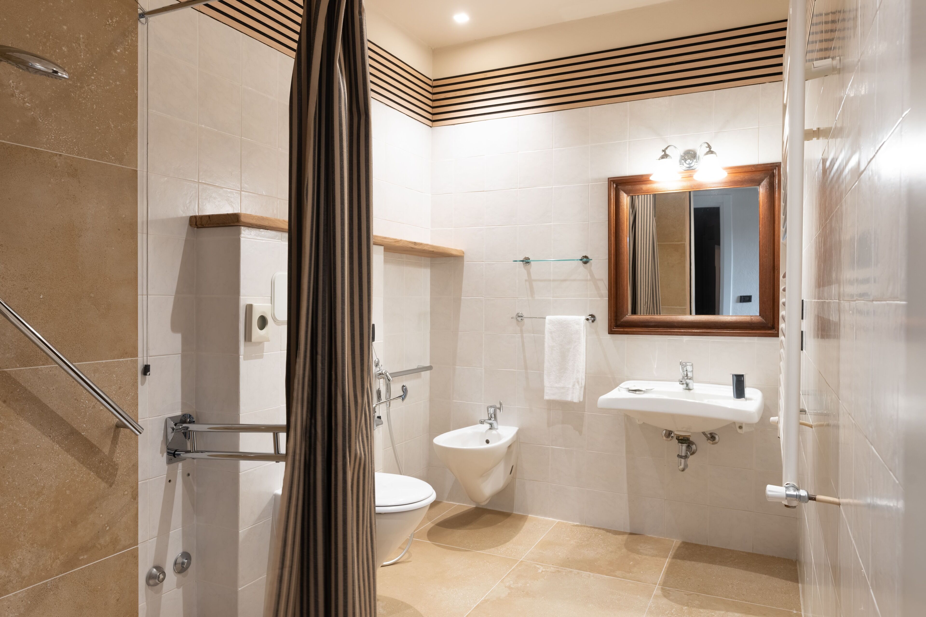 A modern bathroom with a shower, toilet, and sink.