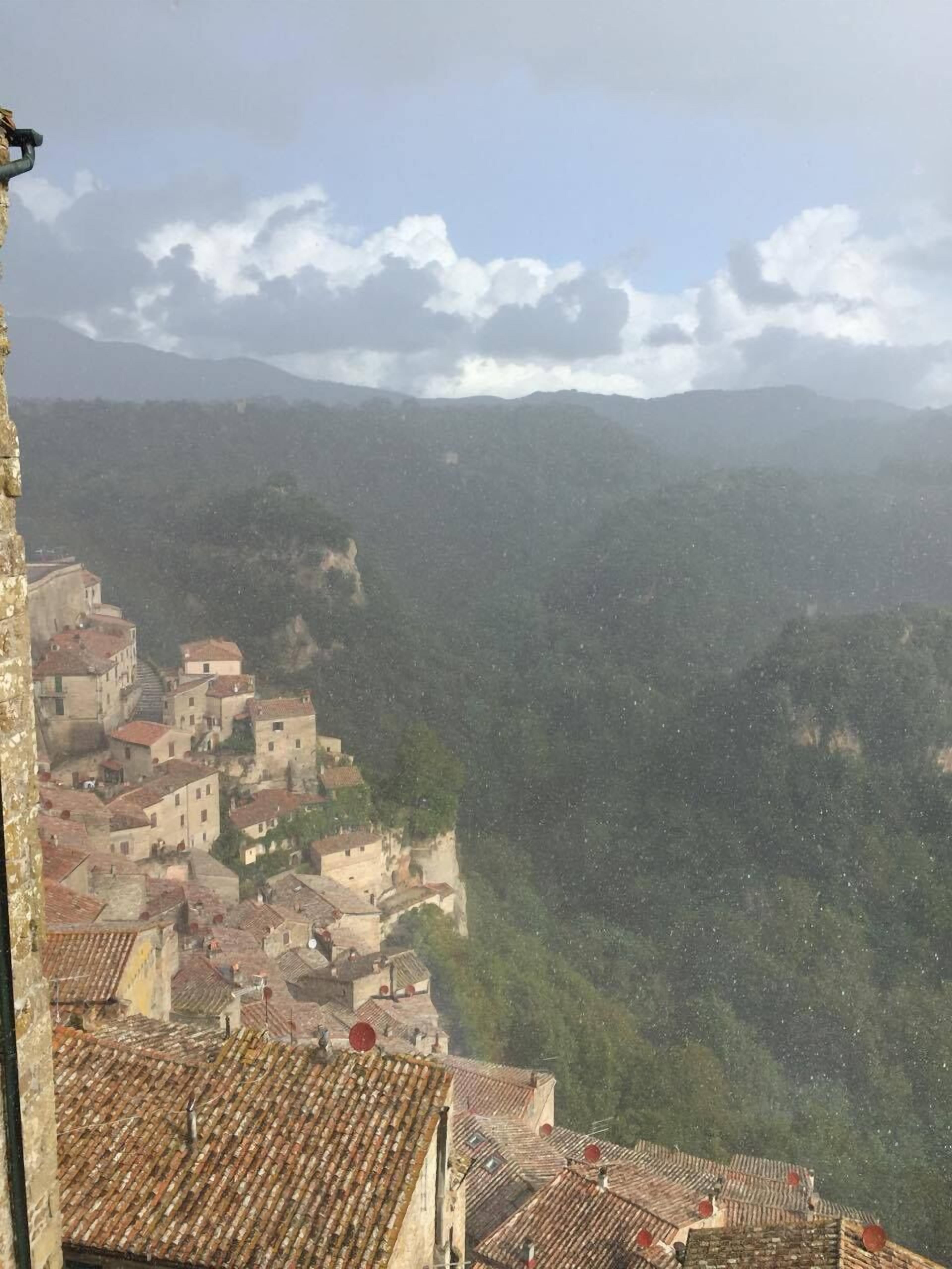 A mountainous village with terracotta-roofed buildings.
