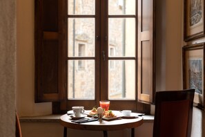 Enjoy a meal for two in this cozy dining area with a view of the city.