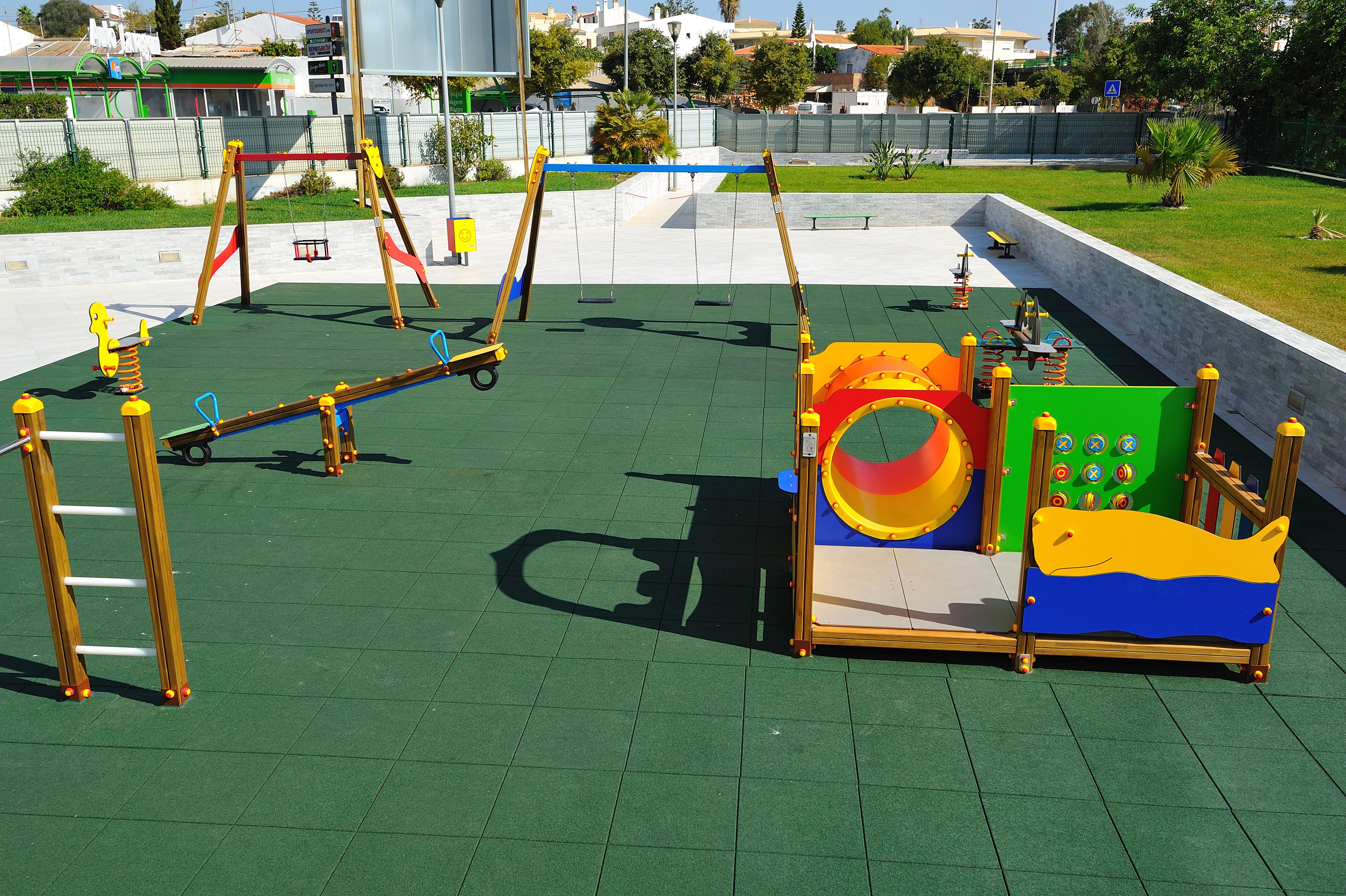 A playground with swings, slides, and climbing structures.