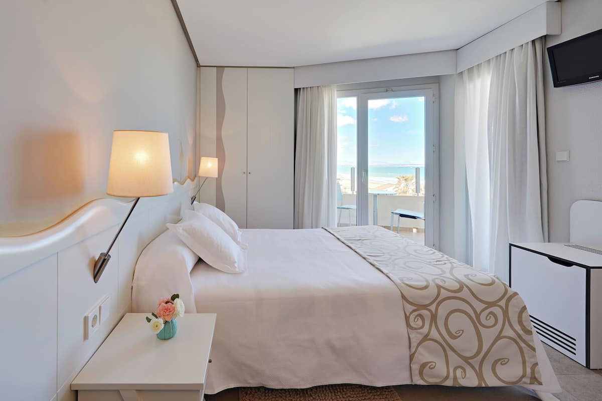 standard double room, balcony, beach view | in-room safe, desk, blackout curtains, iron/ironing board