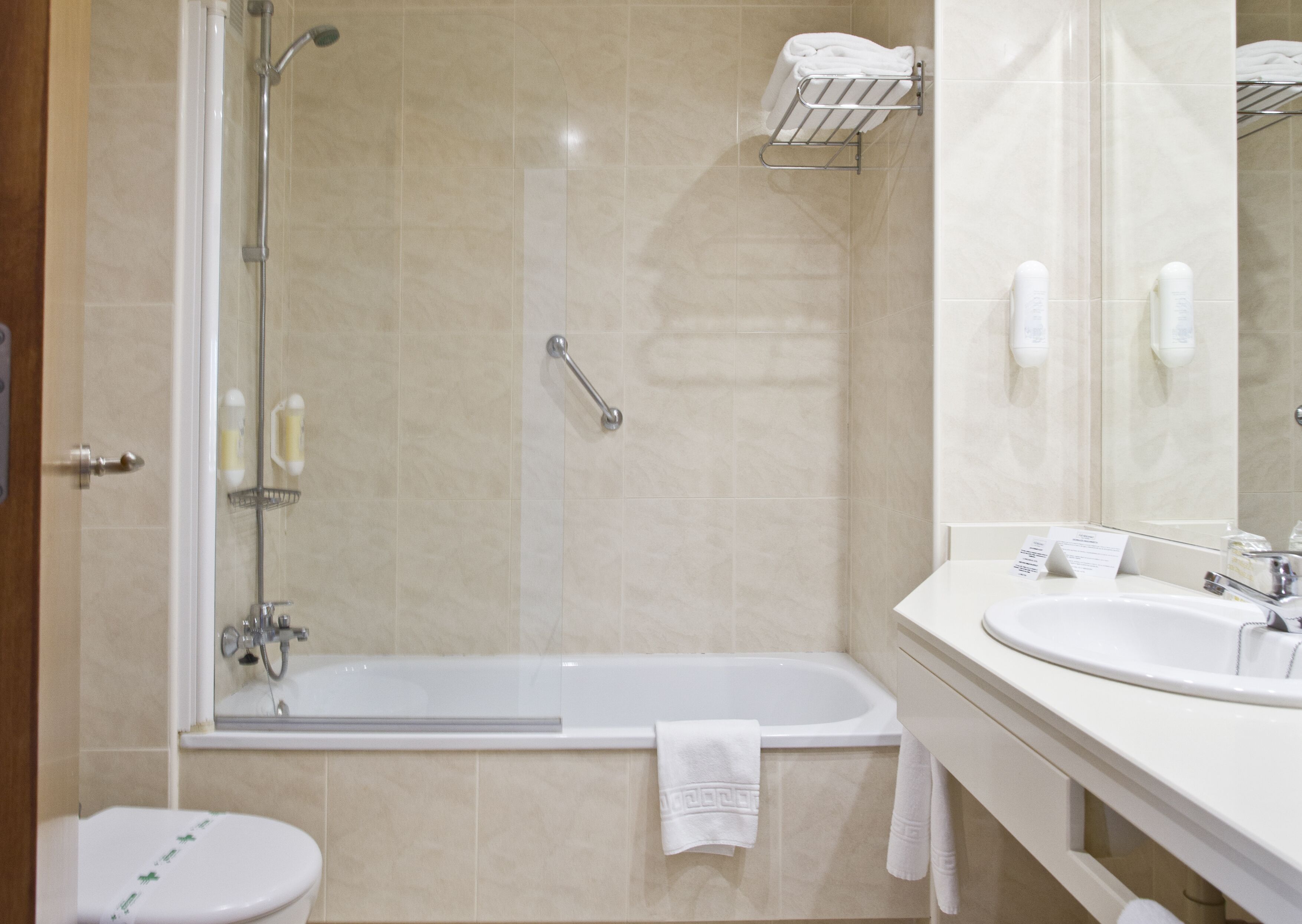 A bathroom with a bathtub, toilet, and sink.