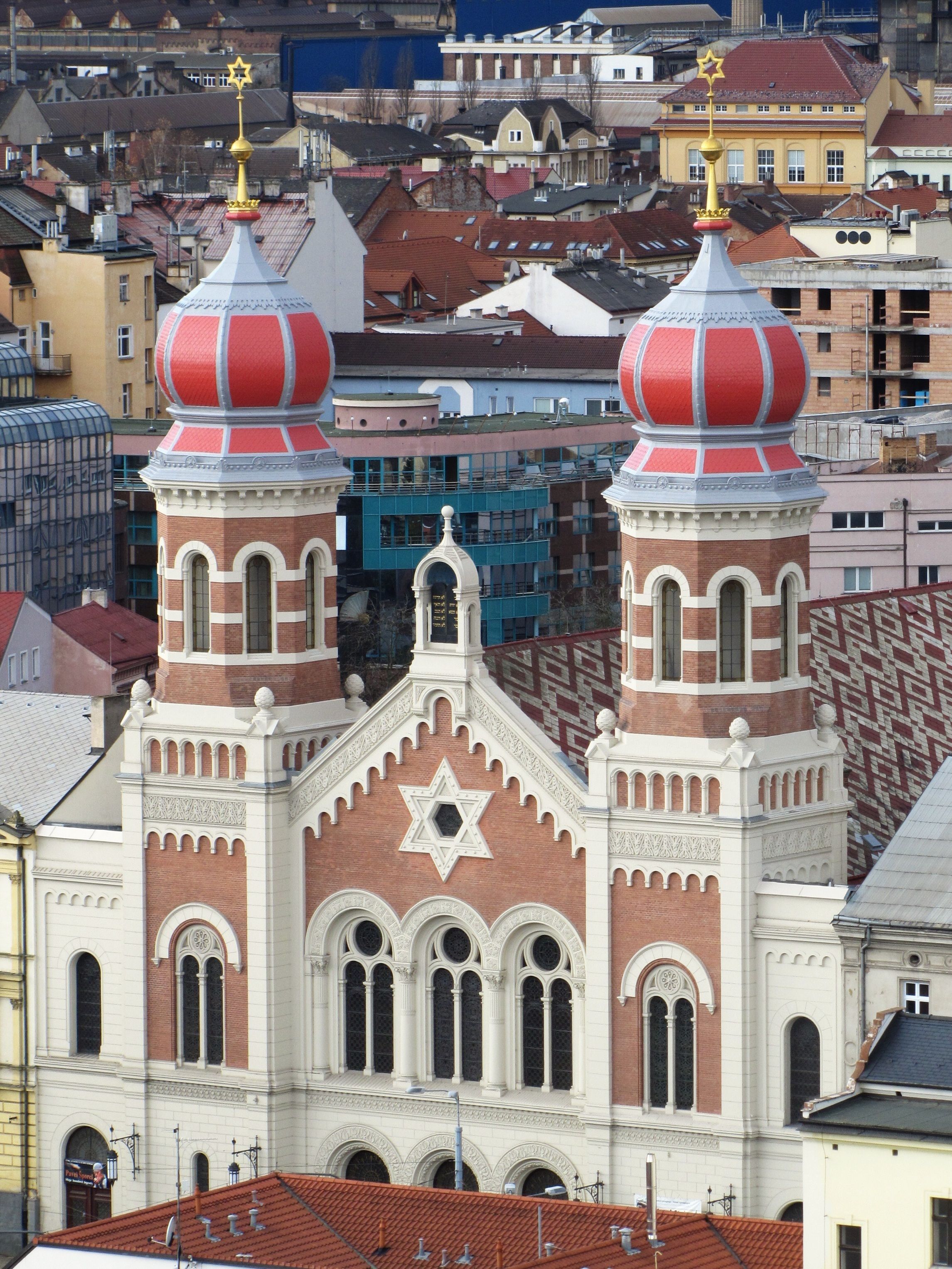 Il s’agit d’un bâtiment historique doté de deux tours imposantes, chacune surmontée d’une étoile dorée et d’une couronne. La façade présente une grande étoile de David et des détails architecturaux complexes.