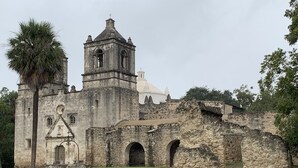 An old stone building with a bell tower and a dome.
