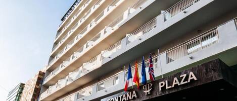 A multi-story hotel building with balconies and a sign for 'FONTANA PLAZA.'