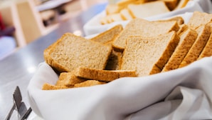 A white ceramic dish containing several slices of whole grain bread. - Hotel Fontana Plaza (Torrevieja)
