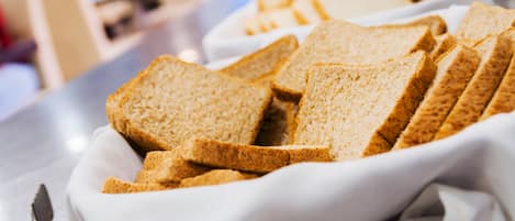 A white ceramic dish containing several slices of whole grain bread.