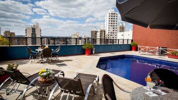 Relax by the pool on a spacious rooftop terrace with a city view.