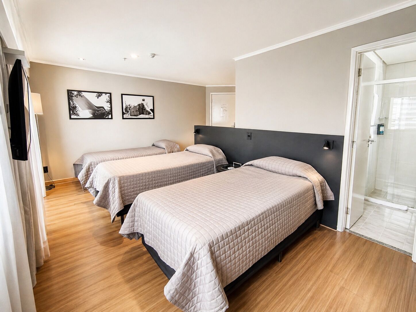 Deluxe Triple Room | Minibar, in-room safe, desk, iron/ironing board