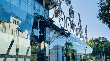 A modern building with large glass windows reflecting the surroundings.
