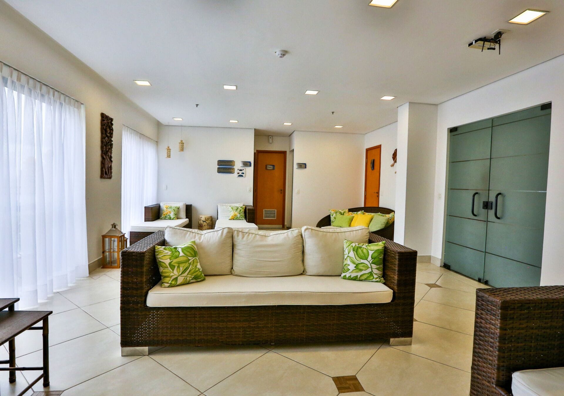 A living room with a sofa, a dining table, and a green cabinet.