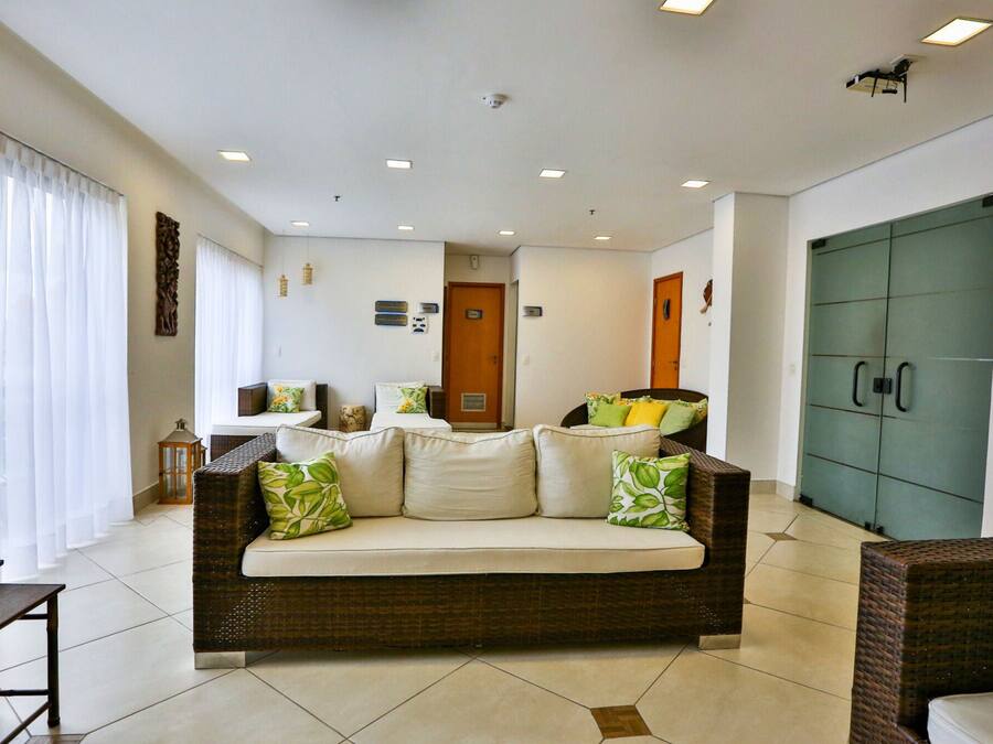 A living room with a sofa, a dining table, and a green cabinet.